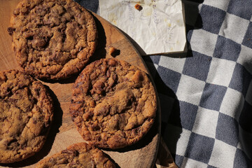 Homemade chocolate chip cookie with old grandma's recipe. Baked goods on cooling rack and tea towel...
