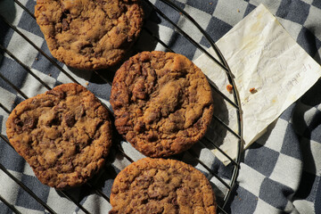 Homemade chocolate chip cookie with old grandma's recipe. Baked goods on cooling rack and tea towel...