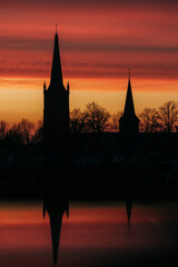 Fototapeta premium Pink sunset with church tower silhouette 