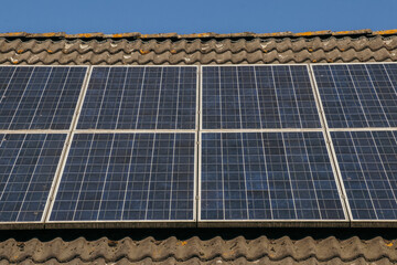 Solar panels on roof. Close up. Clean energy, green energy, sustainability, eco-friendly technology powered by the sun. Renewable energy solutions building house in neighbourhood.