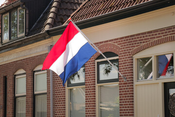 Dutch flag facade neighborhood. National flagging at home. 