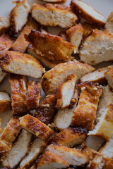 Sliced chicken on plate close up. Slices of grilled fried meat dinner recipe barbecue bbq.