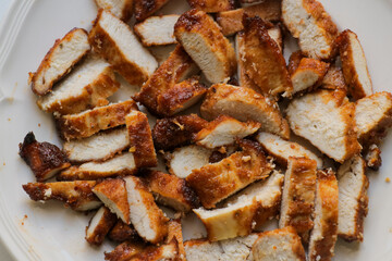 Grilled fried sliced meat chicken on white plate. Dinner lunch recipe. Food photography ingredients. 