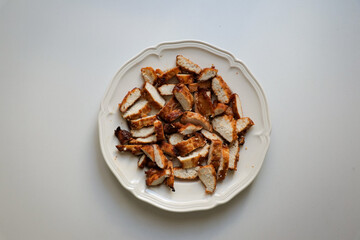 Grilled chicken on white plate dish. Fresh juicy fried barbecue grill chicken dinner prepared. 