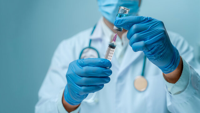 Doctor in blue glove and face mask is filling syringe with vaccine. It represents healthcare, safety, and the professional administration of medicine or vaccines. medical care and public health.