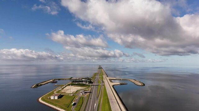 Afsluitdijk causeway crossing ijsselmeer lake under cloudy sky