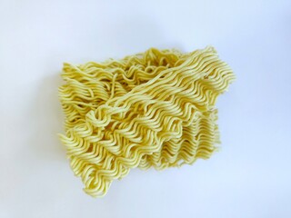 Close up of raw instant noodles on a white surface.