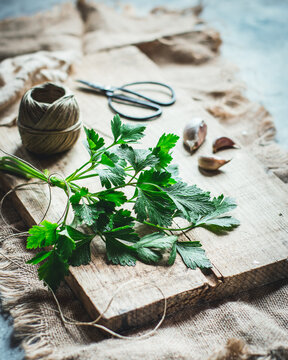 Fresh parsley on rustic wooden cutting board