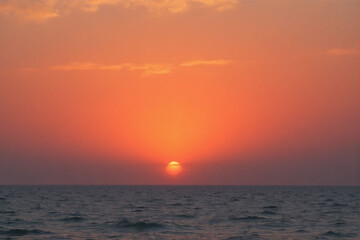 Obraz premium sunset over the ocean with the sun setting in the distance3