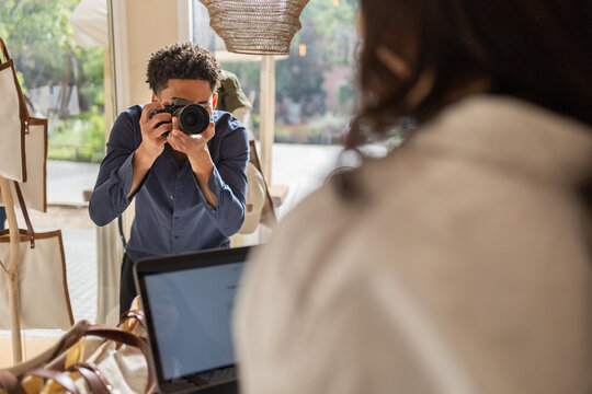 Photographer capturing moments in a bag store environment