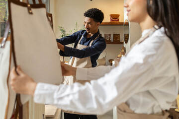 Young shop assistants organizing bags in retail store