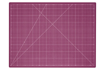 Large pink cutting mat with white grid and measurement marks is isolated. Top-down view.