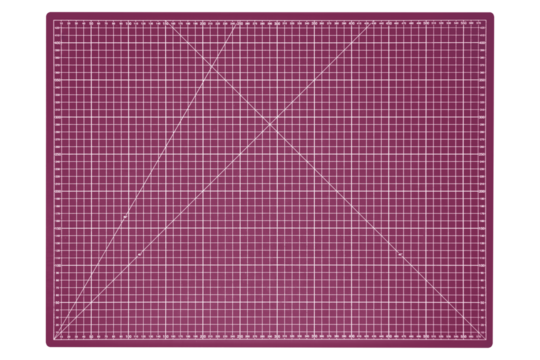 Large pink cutting mat with white grid and measurement marks is isolated. Top-down view.