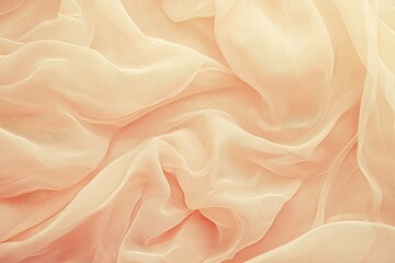 Obraz premium A soft, peach-colored fabric with gentle folds and a warm, sunlit glow