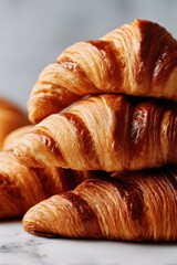 Stack of delicious flaky croissants in morning light