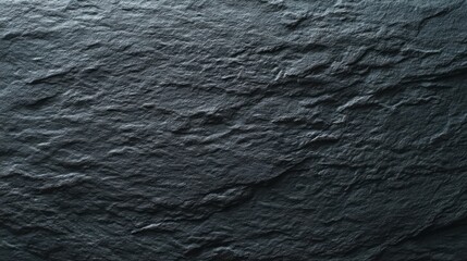 Textured black slate surface with natural stone pattern, showcasing minimalist elegance and raw beauty.