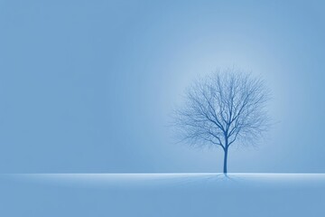 A solitary, bare-branched tree stands silhouetted against a muted blue sky