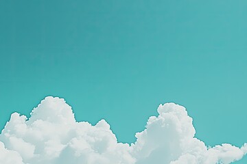 A bright turquoise sky with fluffy white clouds near the bottom of the frame
