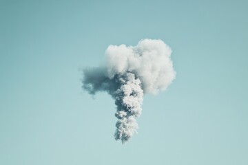 Naklejka premium A large, fluffy cloud of gray smoke against a pale teal sky