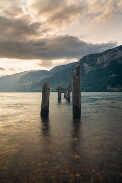 Weathered Wooden Pier Remains in Walensee Lake at Sunset