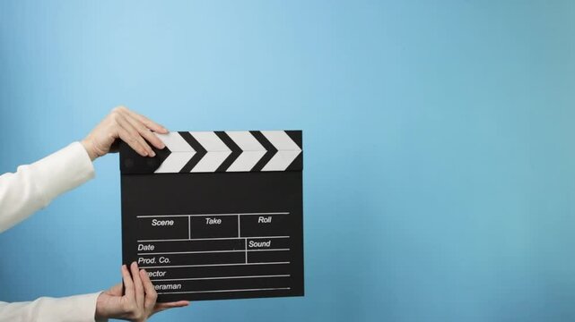 Clapperboard being used in a film scene, representing action, production, and filmmaking