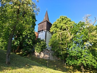 Church of St John the Baptist in Klucov Skramniky surrounded by fields, small village landmark.

