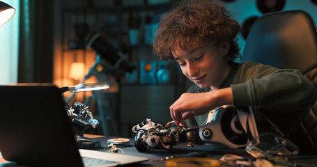 Focused on his robot project, the boy uses tools and a soldering iron to build a device. He learns...