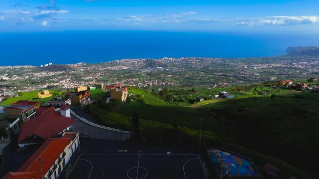 Puerto de la cruz coastline from benijos, showing houses and greenery, aerial view