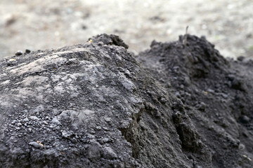 A black pile of fertile soil for adding to lawns