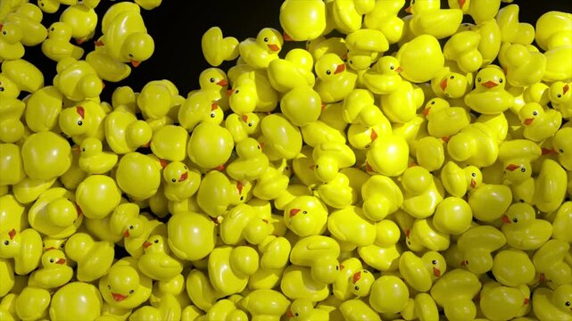 Small yellow rubber ducks falling and accumulating in massive pile against stark black background, creating playful visual pattern of childhood joy and whimsy