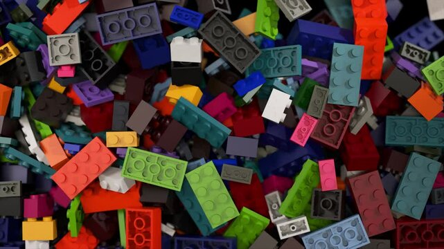 Colorful plastic construction bricks cascading, ricocheting, and gathering on stark black background, generating dynamic, playful visual composition displaying creative toy movement