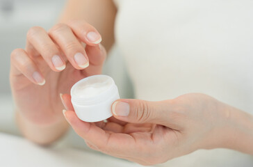 Good skin woman use cream for good skin. face of a healthy woman apply cream and makeup. Advertisement for skin cream, anti-wrinkle, baby face, whitening, moisturizer