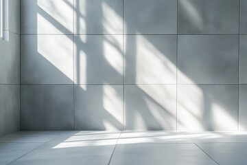 Obraz premium Sunlight streams through a window, casting shadows on light gray tile walls and floor