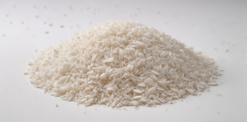 A mound of uncooked white rice on a plain white surface , staple food, photography, food
