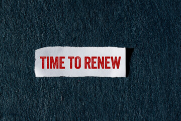 Time to renew message written on ripped torn paper piece with gray background. Conceptual time to...