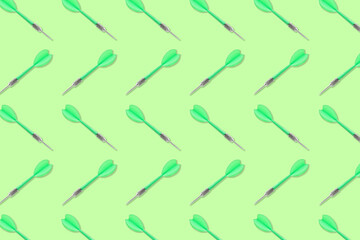 Pattern of darts on light green background