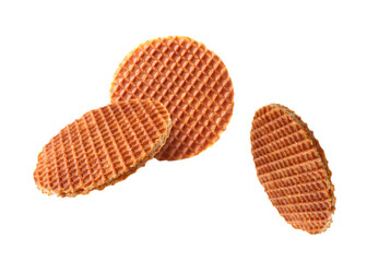 Yummy Dutch waffles (stroopwafels) flying on white background
