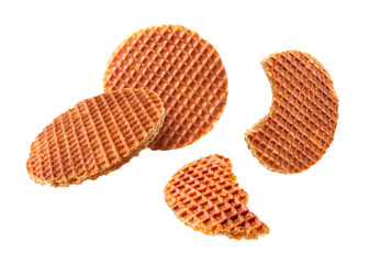 Yummy Dutch waffles (stroopwafels) flying on white background