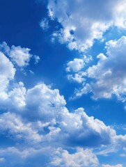 Fototapeta premium Bright blue sky filled with fluffy white clouds, creating a serene atmosphere for relaxation