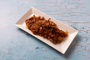 Lebanese moussaka stew served on a rectangular white ceramic plate.
