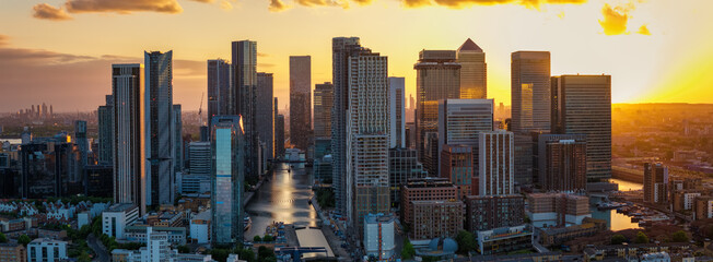Aerial sunset view of the residential and office skyscrapers at Canary Wharf London, England, with the skyline of the City in the background