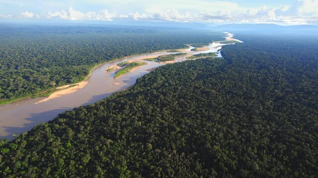 Aerial view reveals Peru&rsquo;s mighty Amazon winding through endless stretches of lush green rainforest. Tambopata reserve