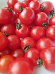 Cherry tomatoes on a white background. Close-up, selective focus.