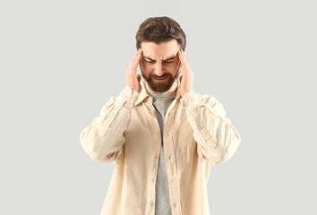 Portrait of worried man on light background