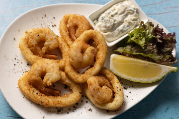 Golden fried calamari and shrimp rings served with tartar sauce.
