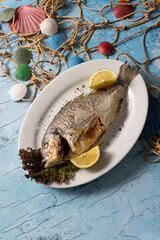 grilled fish, whole fish, seafood, lemon, sea bream, dorado, food photography, rustic, gourmet, plate, lettuce, Mediterranean, fish dish, ocean theme, cooked fish, fresh, herbs, roasted, main course, 