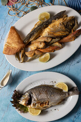 Lebanese seafood platter with sides, served on styled mezze table.