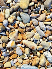 Pebbles on the beach as an abstract background. Texture.