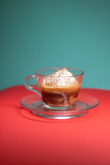 Affogato served in glass cup with whipped cream and espresso.