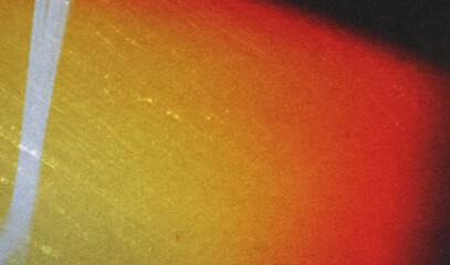 grainy colorful warm orange light leaks on black background with dust texture. abstract damaged...